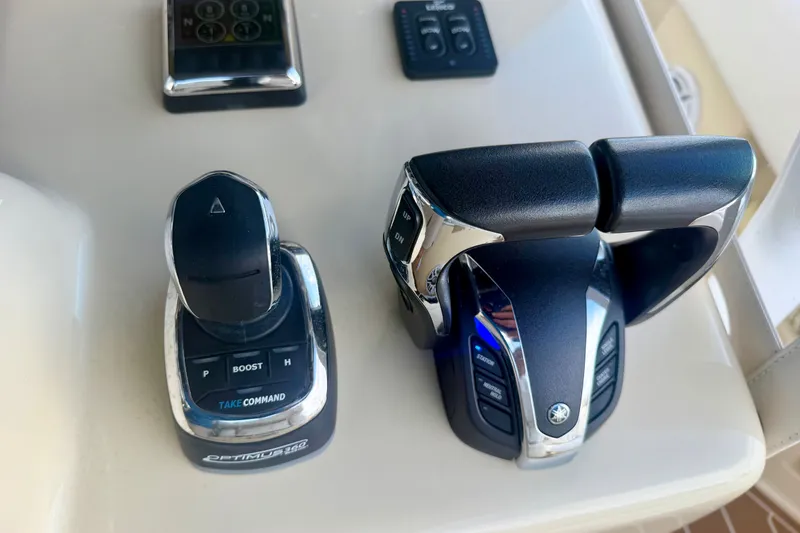 Slide: The Image of Boat controls on a 2021 Conch 33, featuring Optimus 360 joystick and throttle levers. - 22