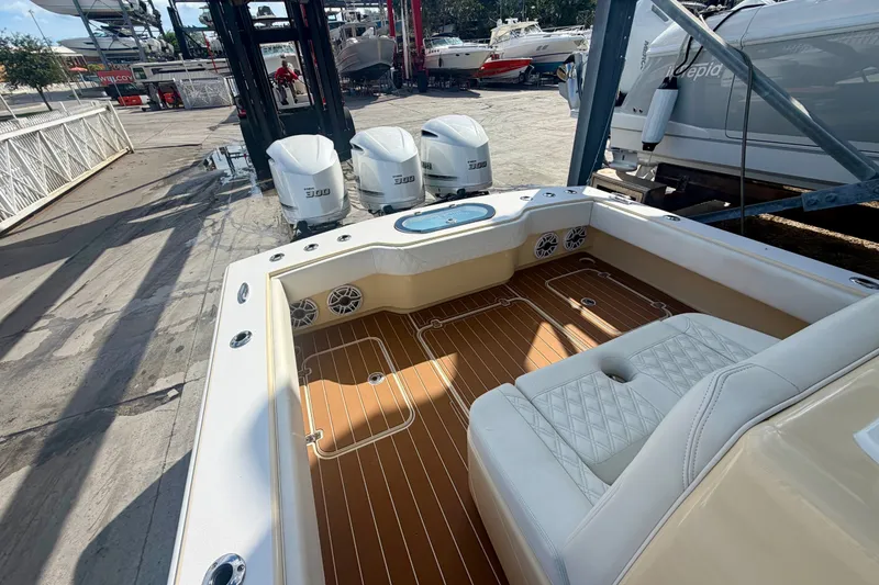 Slide: The Image of 2021 Conch 33 boat interior with triple engines, docked at a marina. - 8