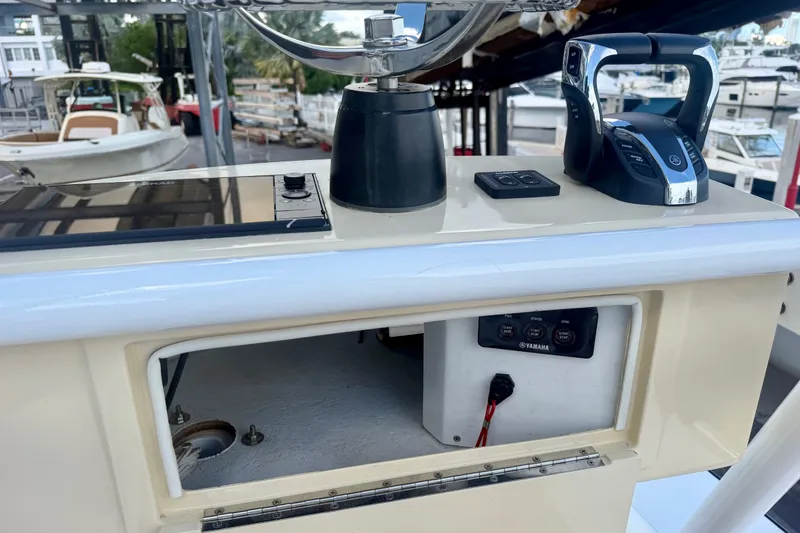 Slide: The Image of Control panel of a 2021 Conch 33 boat with Yamaha controls and open compartment. - 25