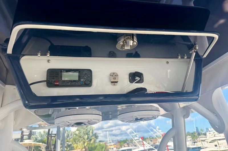 Slide: The Image of 2021 Conch 33 boat electronics compartment with radio and controls. - 19