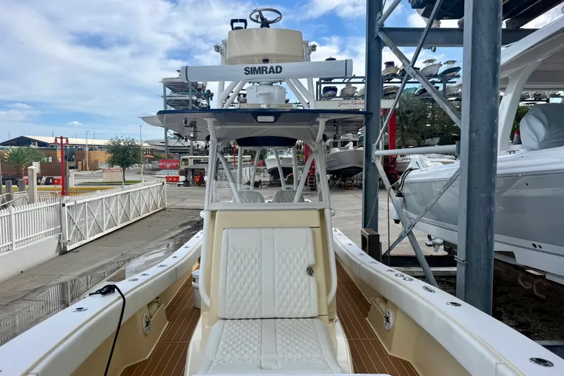 Slide: The Image of 2021 Conch 33 boat docked, featuring Simrad electronics and white seating. - 9