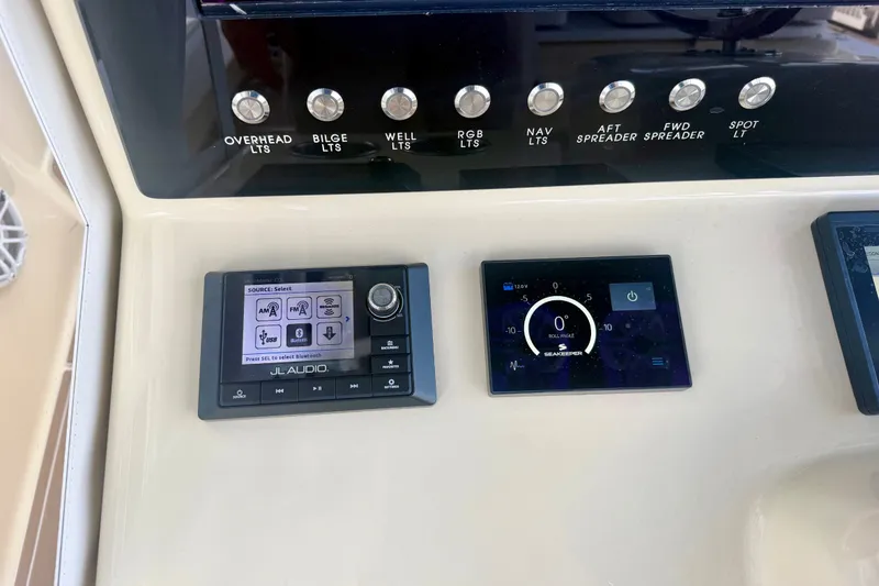 Slide: The Image of Control panel of a 2021 Conch 33 boat with audio and navigation displays. - 24