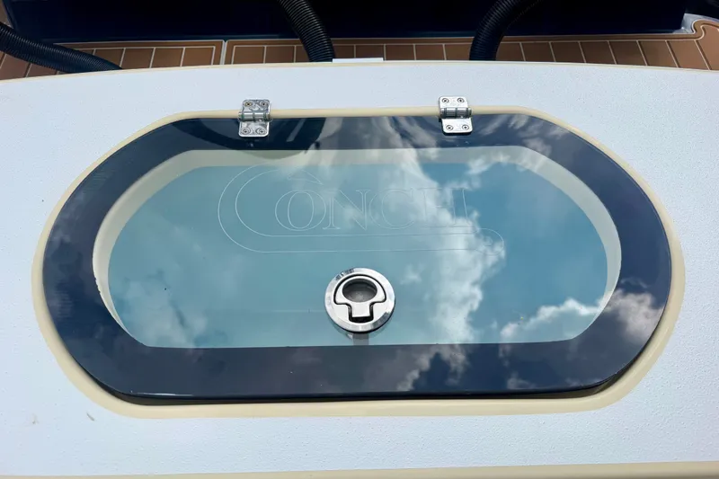 Slide: The Image of Livewell on 2021 Conch 33 boat with reflective glass lid and secure latch. - 21