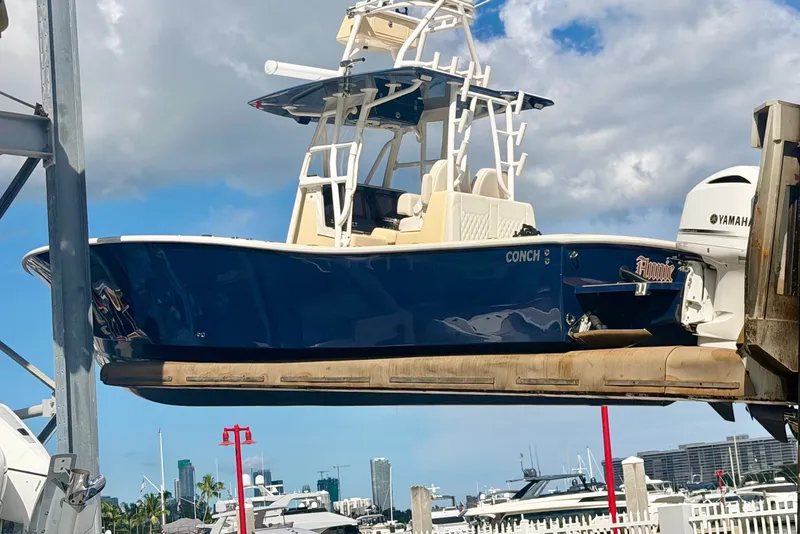 Slide: The Image of 2021 Conch 33 boat with Yamaha engine on lift, marina background. - 5