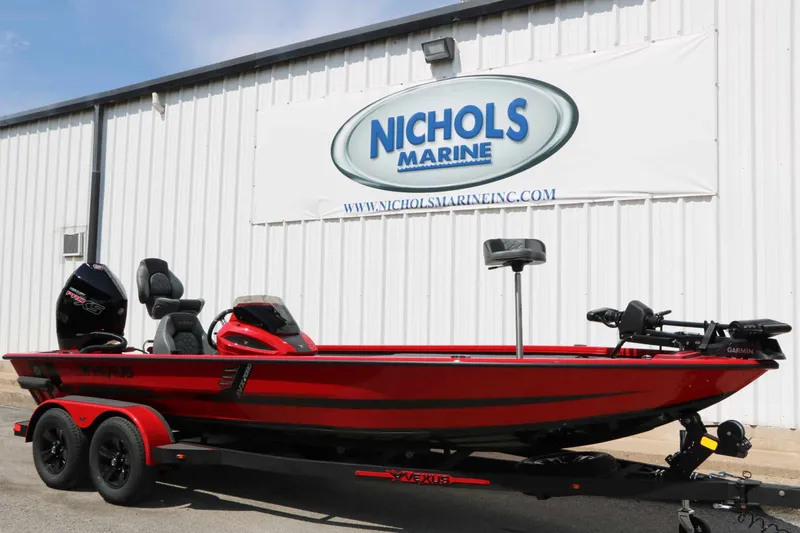 Slide: The Image of A red 2027 Vexus AVX 2080 boat on a trailer in front of a building with a Nichols Marine sign. - 5