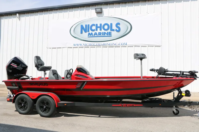 The Image of A red 2027 Vexus AVX 2080 boat on a trailer in front of a building. - 1
