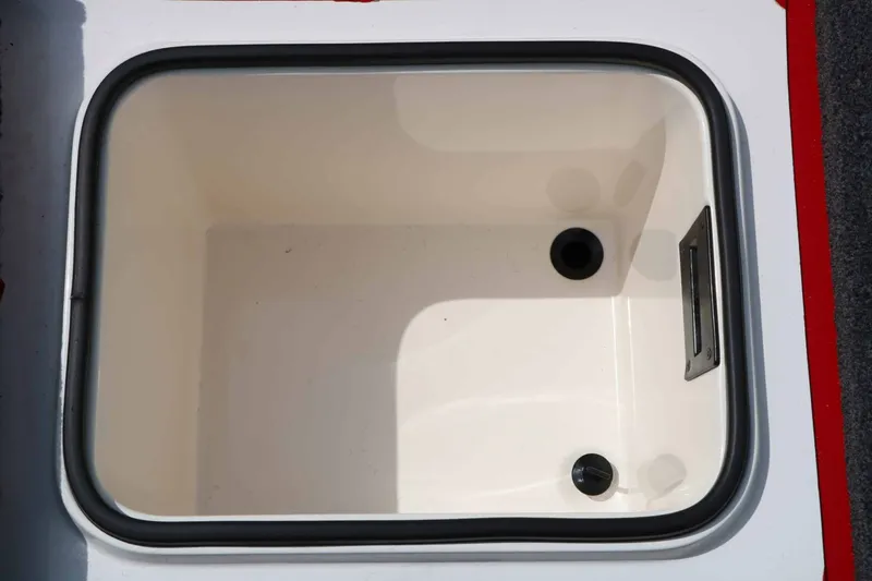 Slide: The Image of An open, rectangular storage compartment with smooth white walls and two drains at the bottom. - 45
