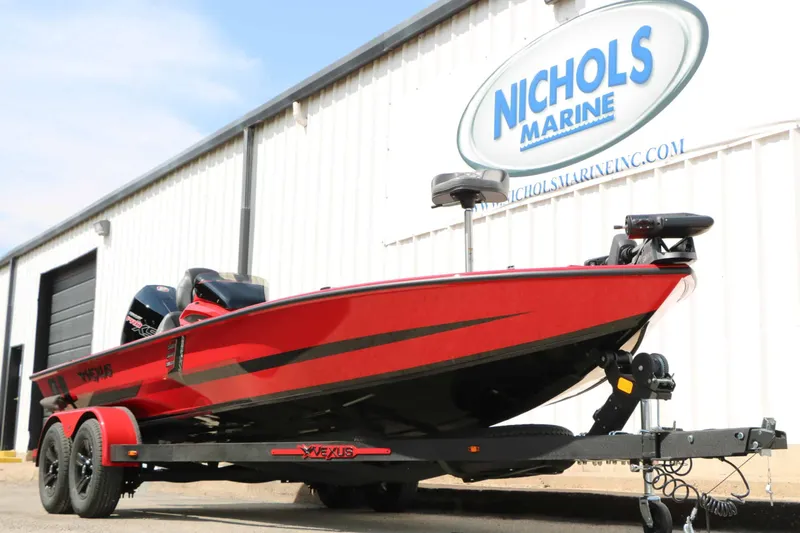 Slide: The Image of Vexus AVX 2080 from 2027 in front of a building with a "Nichols Marine" sign. - 8