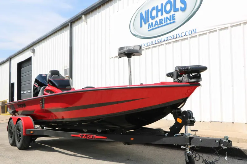 Slide: The Image of A red Vexus AVX 2080 boat from 2027 on a trailer in front of a building. - 7