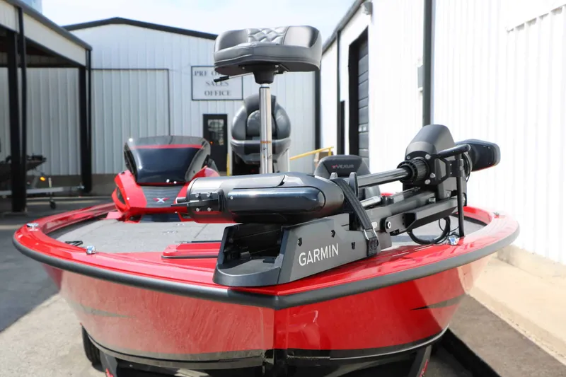 Slide: The Image of A red 2027 Vexus AVX 2080 boat with Garmin equipment, parked in a storage area. - 9