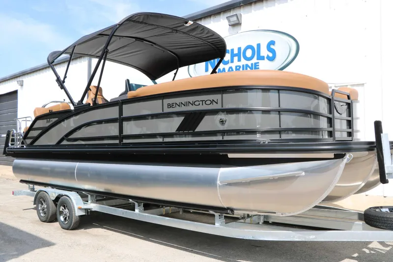 Slide: The Image of A sleek 2027 Bennington 24 MSL Tri Toon sits on a trailer outside a building. - 5