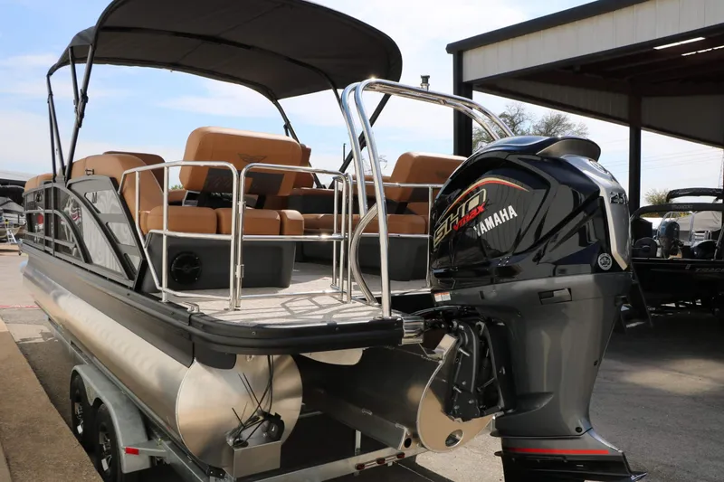 Slide: The Image of A 2027 Bennington 24 MSL Tri Toon with Yamaha outboard motor, parked on a trailer. - 19
