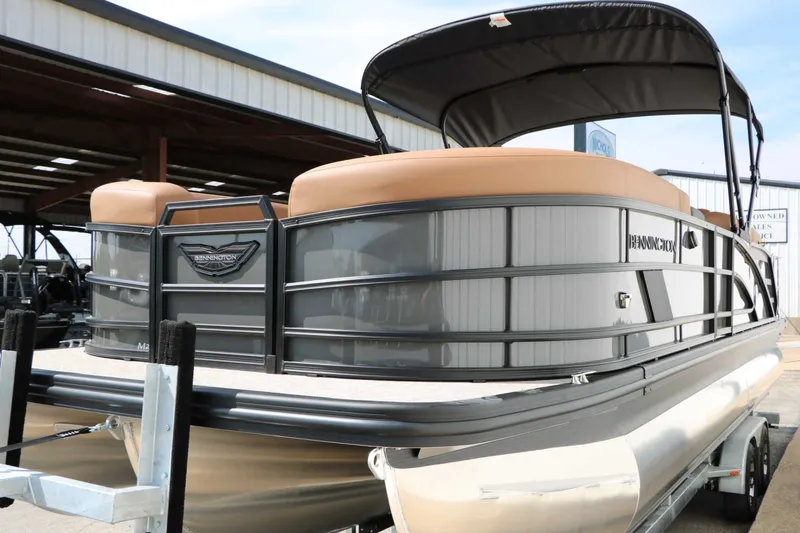 Slide: The Image of A 2027 Bennington 24 MSL Tri Toon on a trailer. It features a modern design. - 11