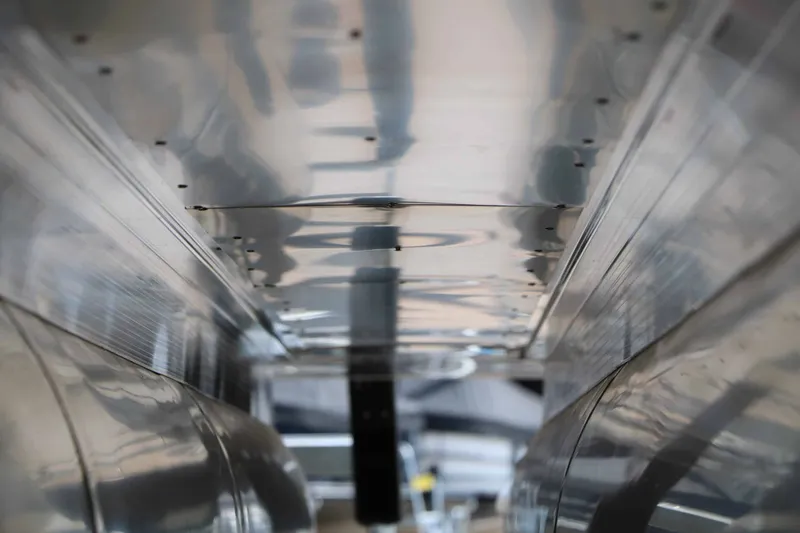 Slide: The Image of Close-up of the shiny aluminum hulls of a 2027 Bennington 24 MSL Tri Toon. - 31