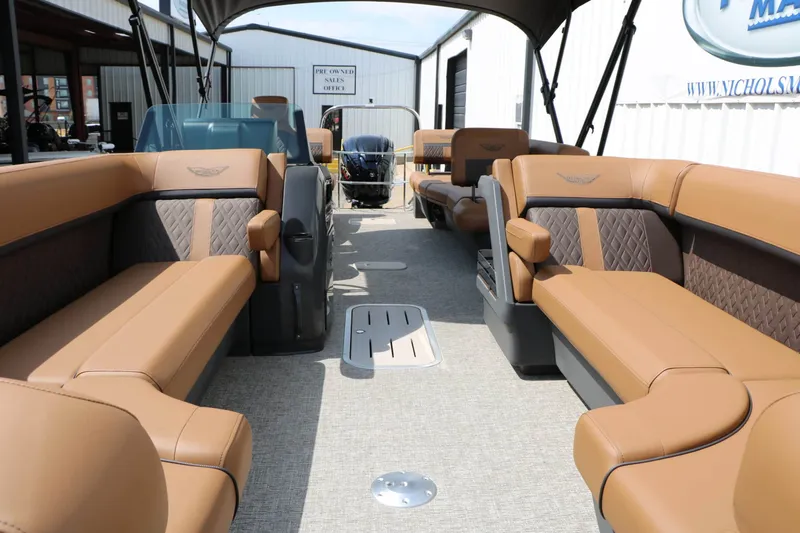 Slide: The Image of The image shows the interior of a 2027 Bennington 24 MSL Tri Toon with luxurious brown leather seating. - 32