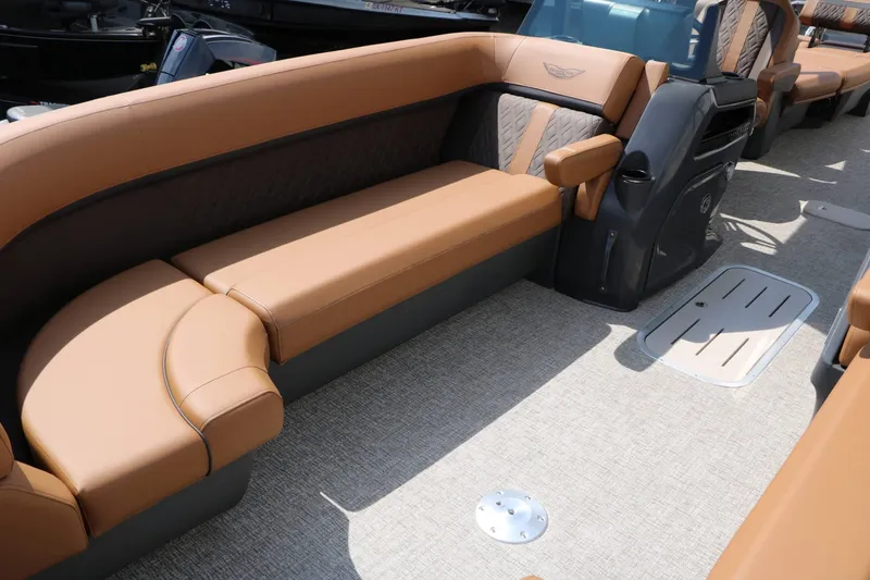 Slide: The Image of The image shows the interior of a 2027 Bennington 24 MSL Tri Toon with sleek brown leather seating. - 34