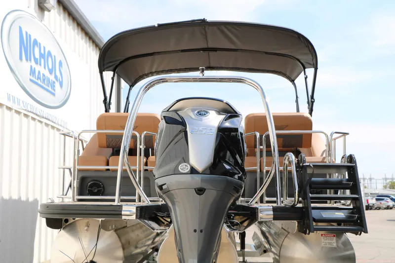 Slide: The Image of A 2027 Bennington 24 MSL Tri Toon with a powerful outboard motor and comfortable seating. - 18