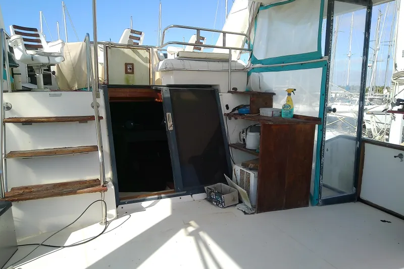 Slide: The Image of 1989 Sea Ray 440 Aft Cabin interior with stairs, seating, and cleaning supplies. - 11