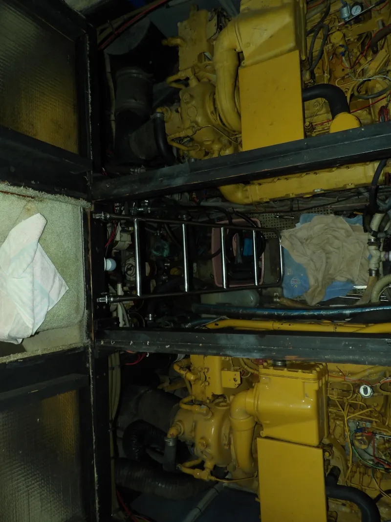 Slide: The Image of Engine room of 1989 Sea Ray 440 Aft Cabin with dual yellow engines. - 64