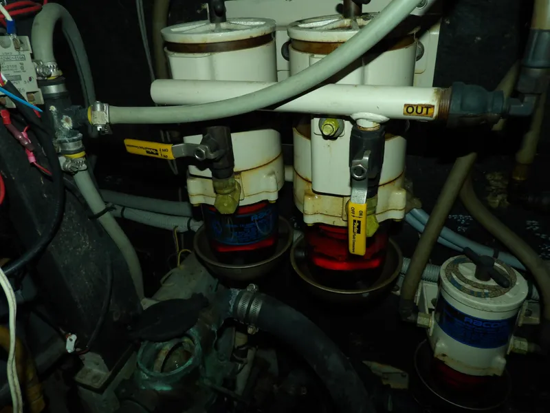 Slide: The Image of Engine room of 1989 Sea Ray 440 Aft Cabin with fuel filters and hoses. - 69