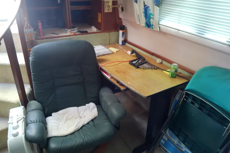 Slide: The Image of Interior of 1989 Sea Ray 440 Aft Cabin with chair, desk, and tools. - 27