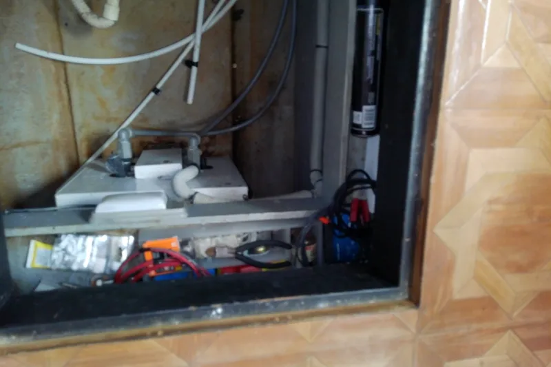 Slide: The Image of 1989 Sea Ray 440 Aft Cabin interior wiring and plumbing components. - 57
