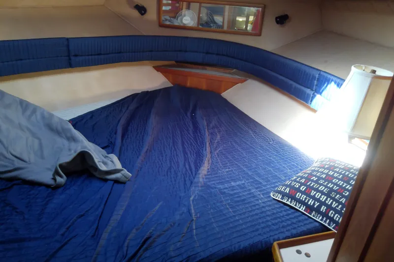 Slide: The Image of Cozy cabin interior of 1989 Sea Ray 440 Aft Cabin with blue bedding. - 43