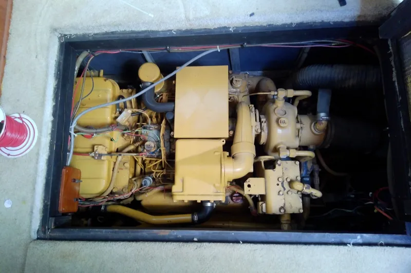 Slide: The Image of Engine compartment of a 1989 Sea Ray 440 Aft Cabin boat, showcasing mechanical components. - 60