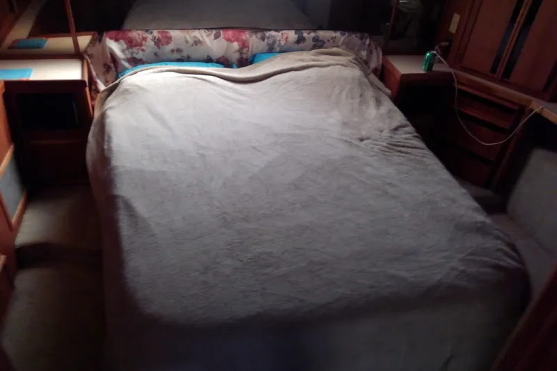 Slide: The Image of Cozy bedroom interior of 1989 Sea Ray 440 Aft Cabin yacht with floral accents. - 44