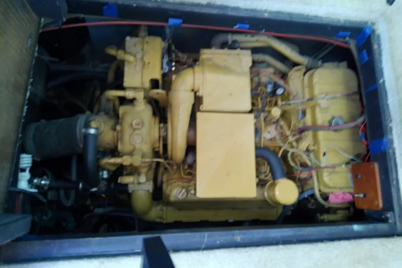 Slide: The Image of Engine compartment of 1989 Sea Ray 440 Aft Cabin boat, showcasing mechanical components. - 59