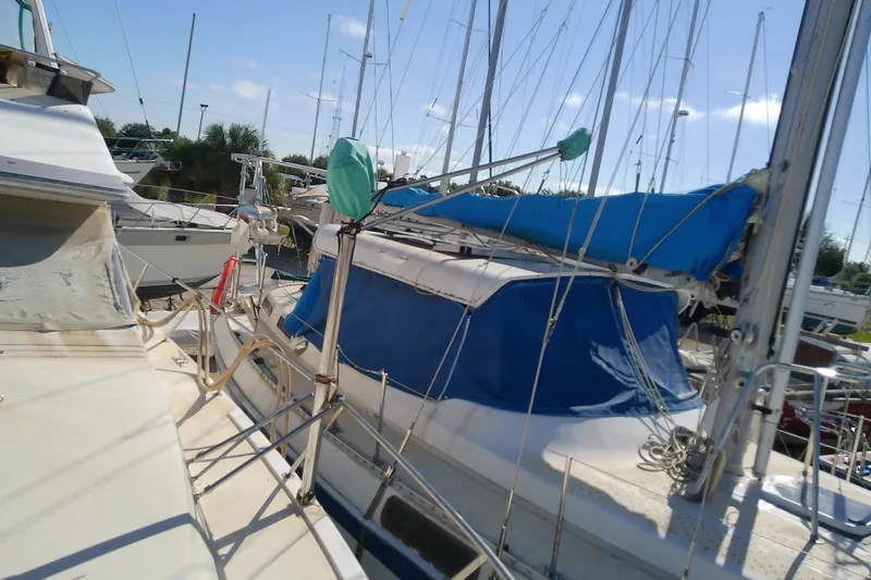 Slide: The Image of 1989 Sea Ray 440 Aft Cabin yacht docked with blue sail cover. - 21