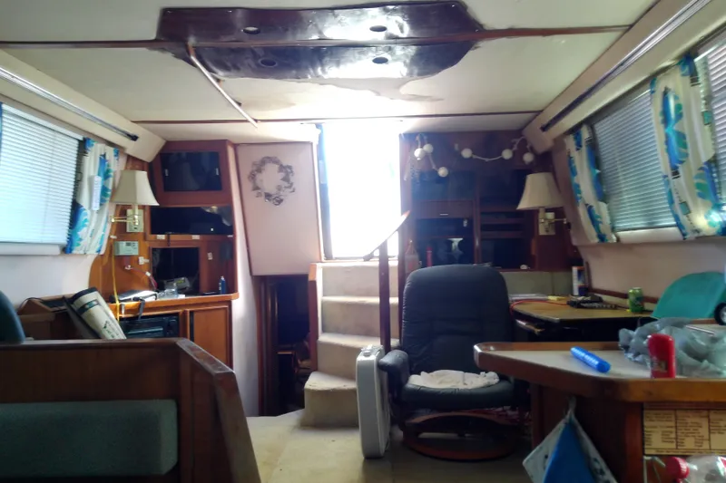 Slide: The Image of 1989 Sea Ray 440 Aft Cabin interior with cozy seating and nautical decor. - 33