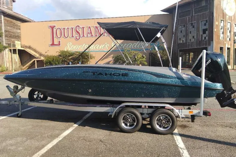 Slide: The Image of 2027 Tahoe 2150 boat on trailer in parking lot, Louisiana Sportsman's Paradise backdrop. - 5