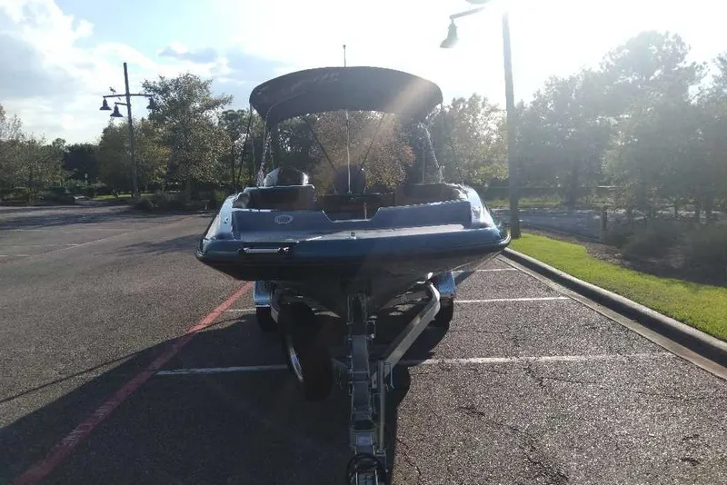 Slide: The Image of 2027 Tahoe 2150 boat on trailer in sunny parking lot. - 7