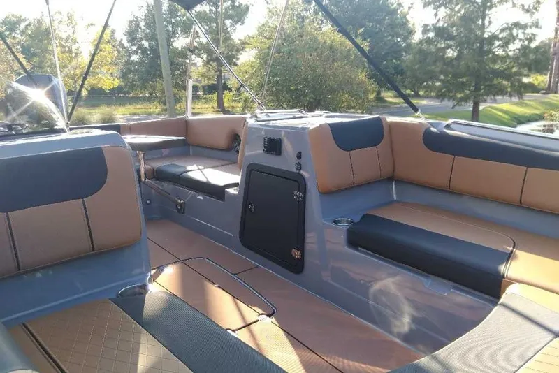 Slide: The Image of Interior of a 2027 Tahoe 2150 boat with tan and black seating. - 8