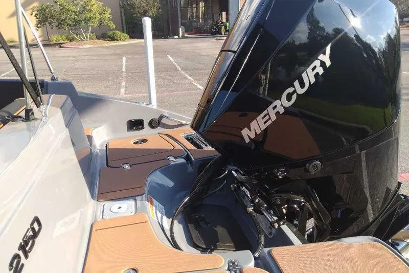 Slide: The Image of Tahoe 2150 boat with Mercury engine, 2027 model, in a parking lot. - 11
