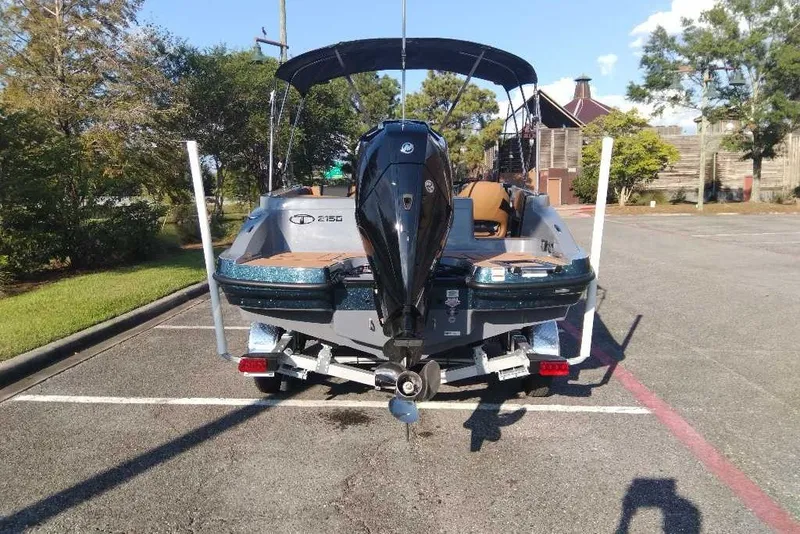 Slide: The Image of 2027 Tahoe 2150 boat on trailer in parking lot, rear view. - 3