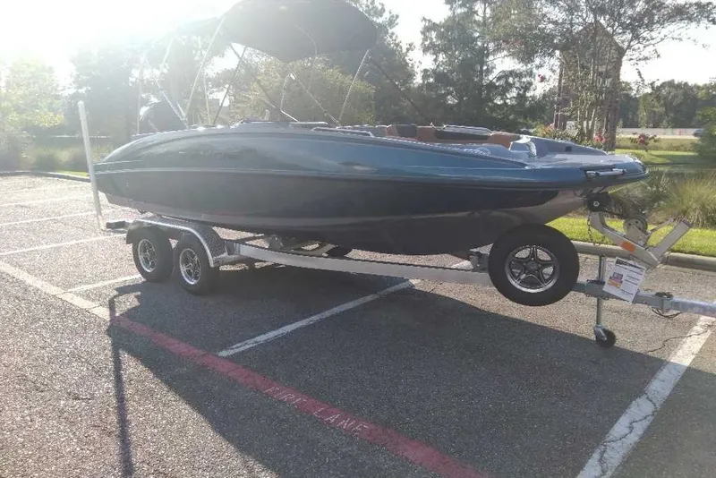The Image of 2027 Tahoe 2150 boat on trailer in sunny parking lot. - 0