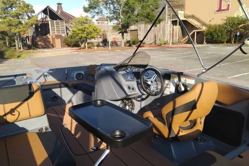 Slide: The Image of Interior of a 2027 Tahoe 2150 boat with modern seating and dashboard. - 10