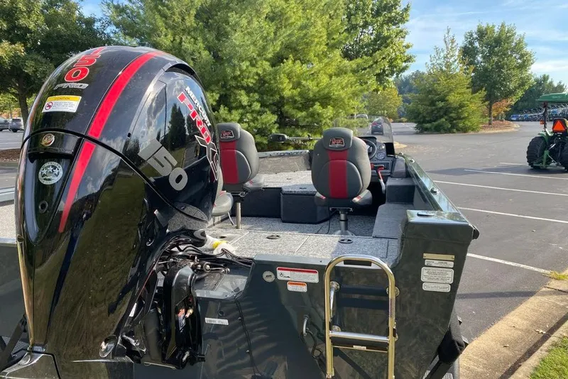 Slide: The Image of 2026 Ranger VS1882SC Angler boat with powerful 150 HP motor in a scenic parking area. - 5