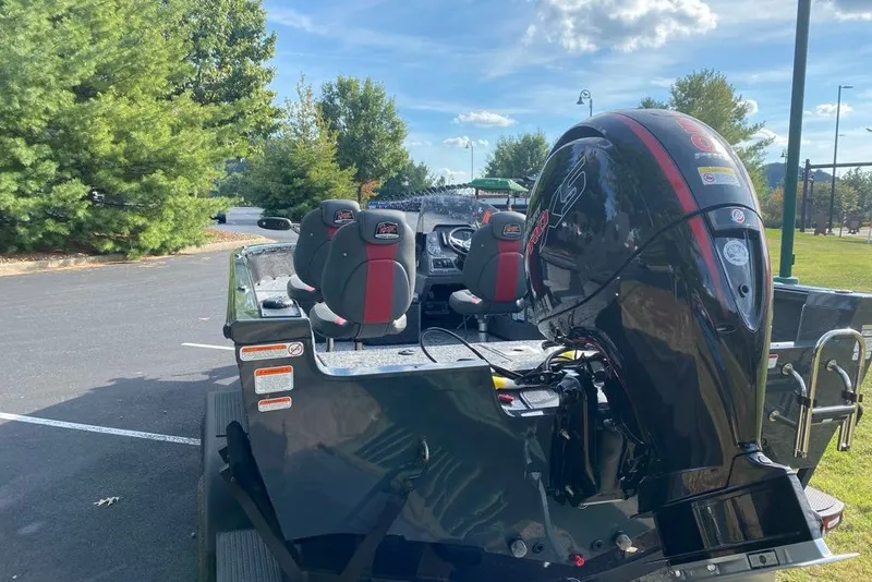 Slide: The Image of 2026 Ranger VS1882SC Angler boat with powerful outboard motor in a sunny parking lot. - 6