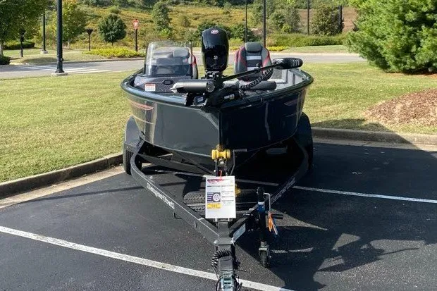 Slide: The Image of 2026 Ranger VS1882SC Angler boat parked on asphalt, surrounded by greenery. - 3