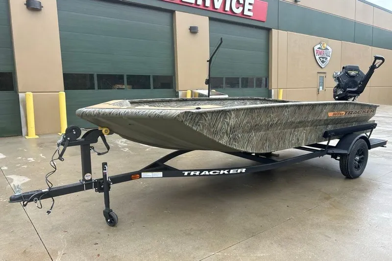 The Image of 2027 Tracker Grizzly 1756 T Marsh boat on trailer outside service center. - 0