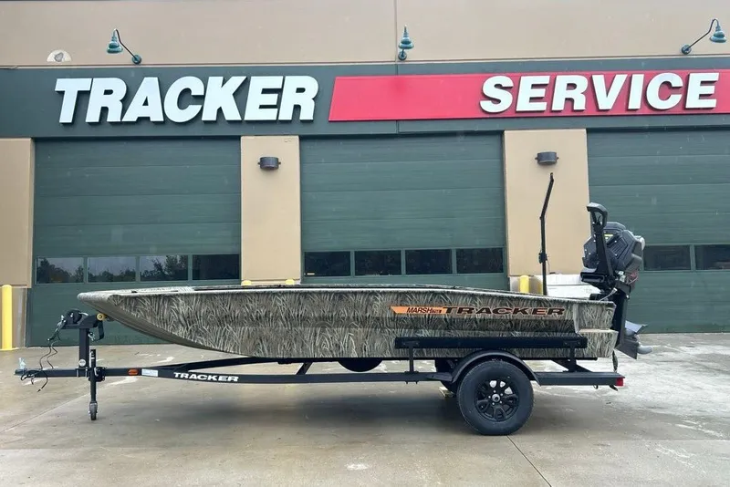 Slide: The Image of 2027 Tracker Grizzly 1756 T Marsh boat on trailer outside service center. - 13