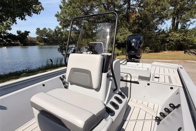 Slide: The Image of 2027 Tracker Bass Tracker 175 CC boat interior with seating, console, and lake view. - 15