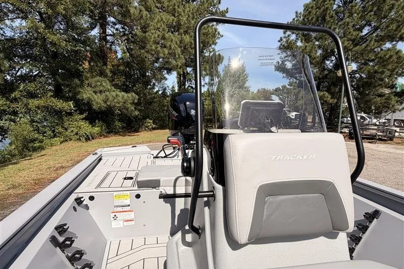 Slide: The Image of 2027 Tracker Bass Tracker 175 CC boat with console, outdoors in wooded area. - 16