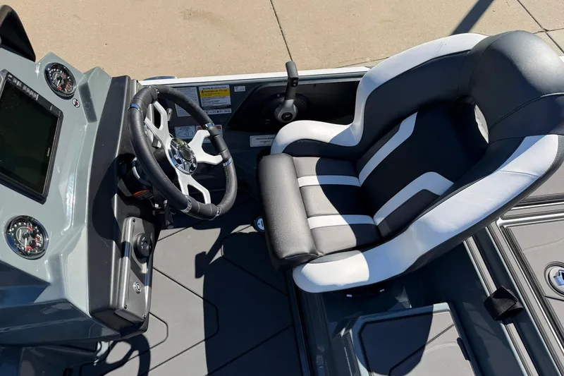 Slide: The Image of 2027 Nitro Z20 XL Pro boat cockpit with steering wheel and cushioned seat. - 25