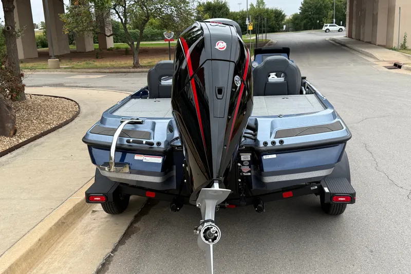 Slide: The Image of 2027 Nitro Z20 XL Pro boat with powerful outboard motor, parked on a street. - 13