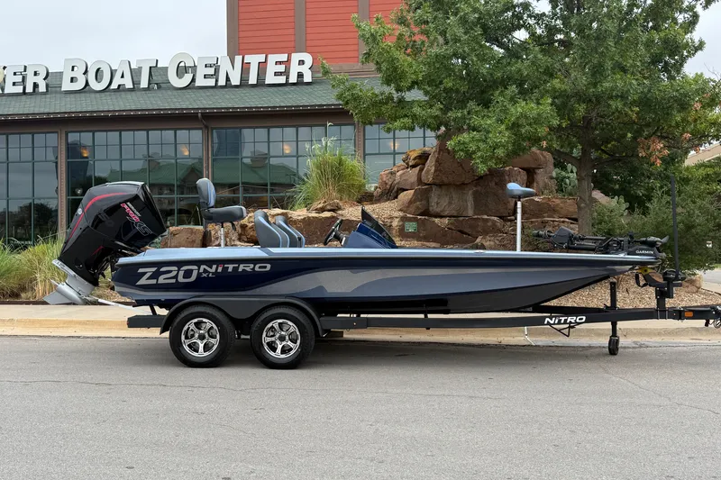 Slide: The Image of 2027 Nitro Z20 XL Pro boat parked outside a boat center, showcasing sleek design and powerful engine. - 10