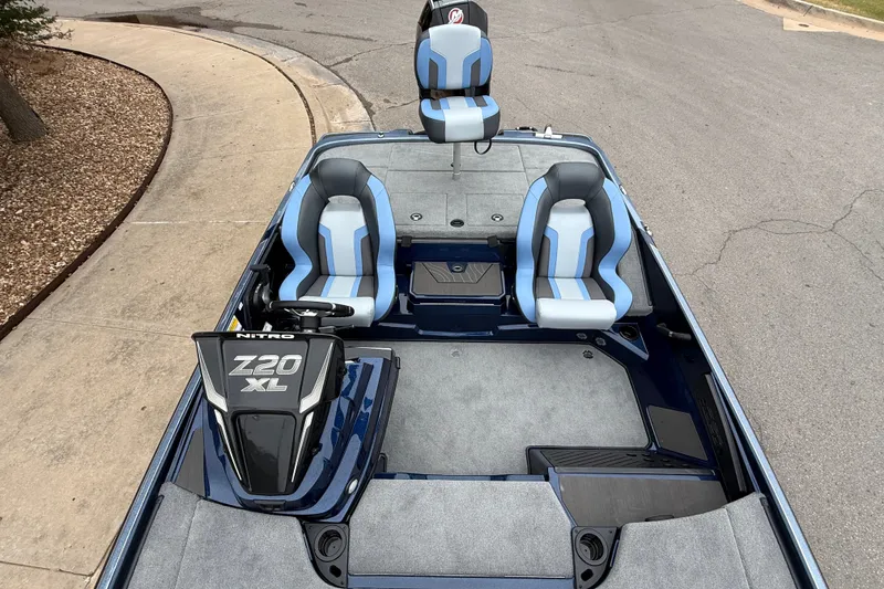 Slide: The Image of 2027 Nitro Z20 XL Pro boat interior with blue and gray seating, steering console. - 9